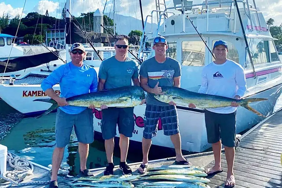 a group of people holding a fish on a boat