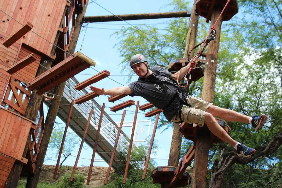 Person swinging on adventure tower